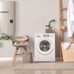 Interior of home laundry room with modern washing machine